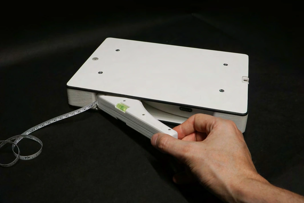 Handheld magnetically attached to the side of the scale.